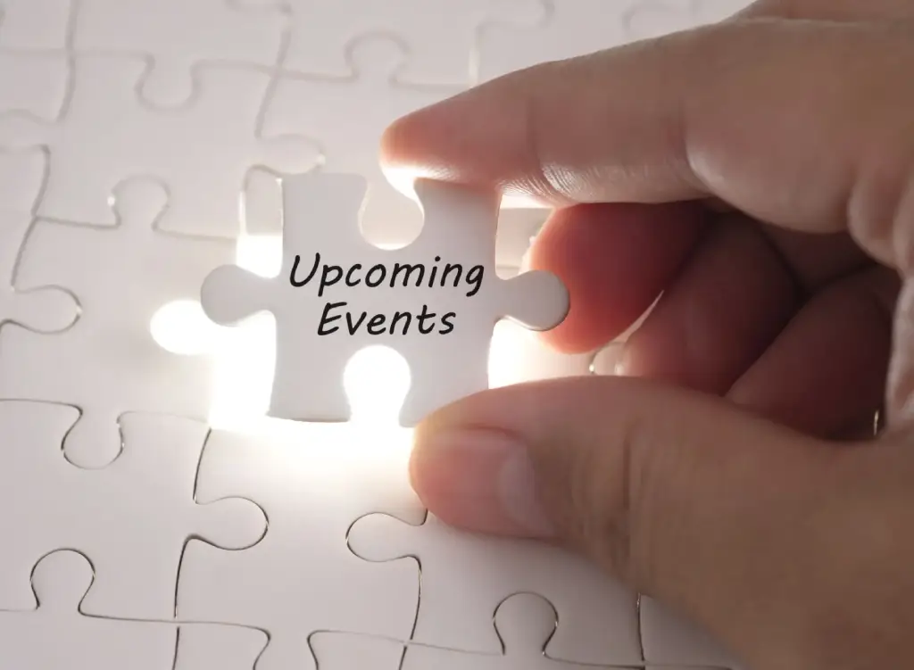 Hand placing a puzzle piece labeled 'Upcoming Events'.