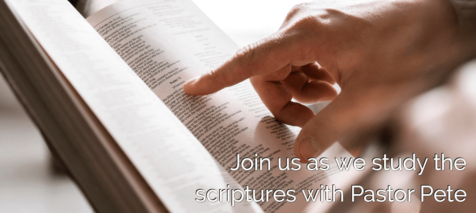 Hand studying a Bible passage