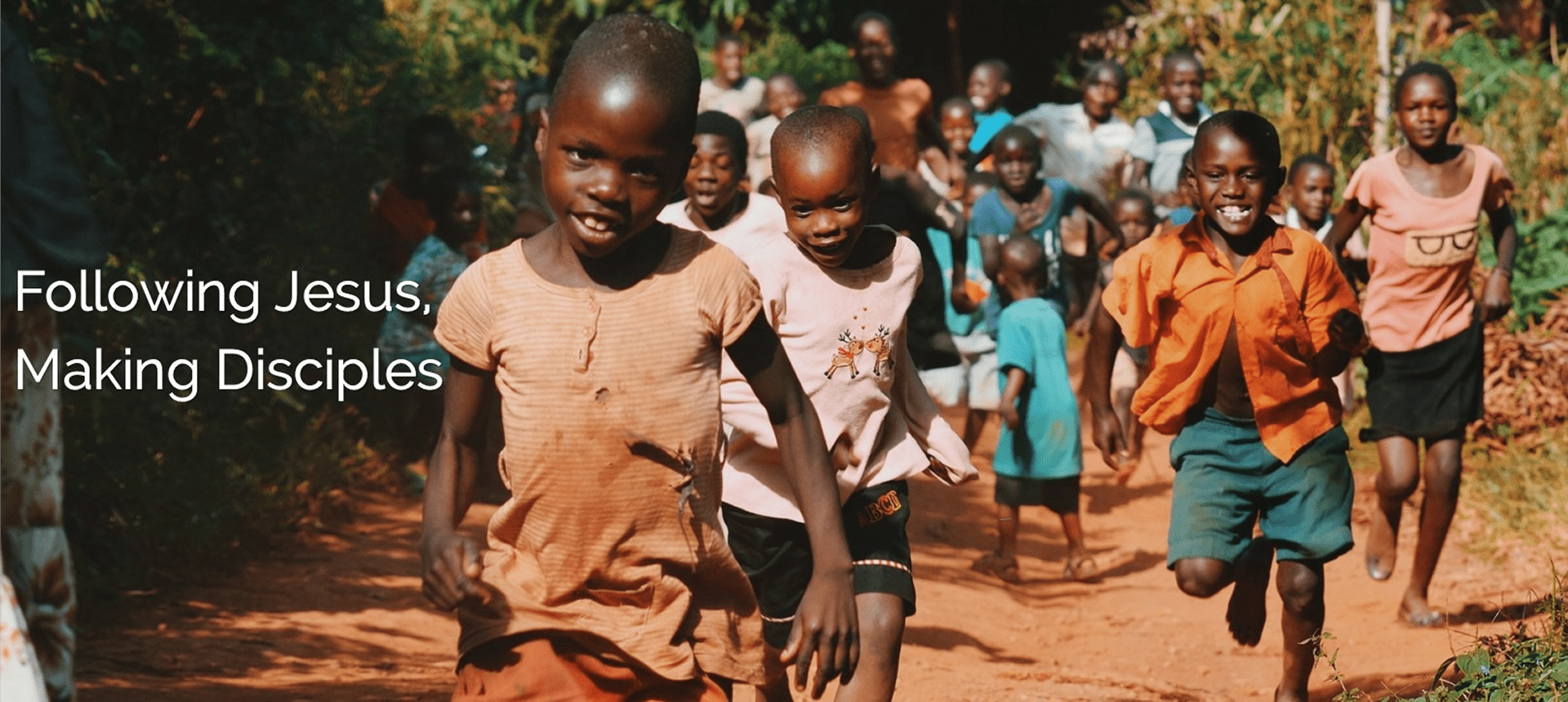Children running on a dirt path